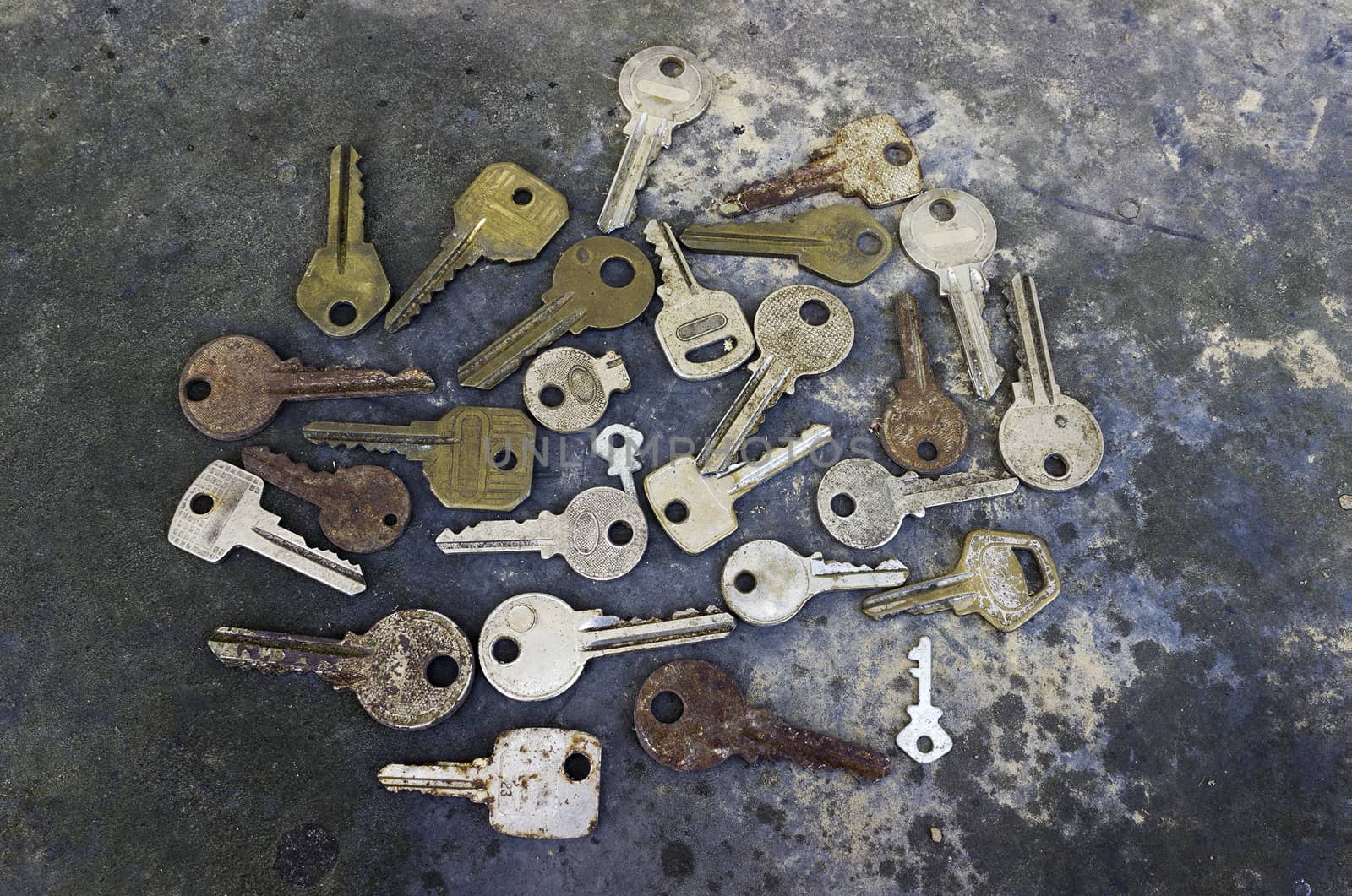 Collection of different old keys on a rustic background