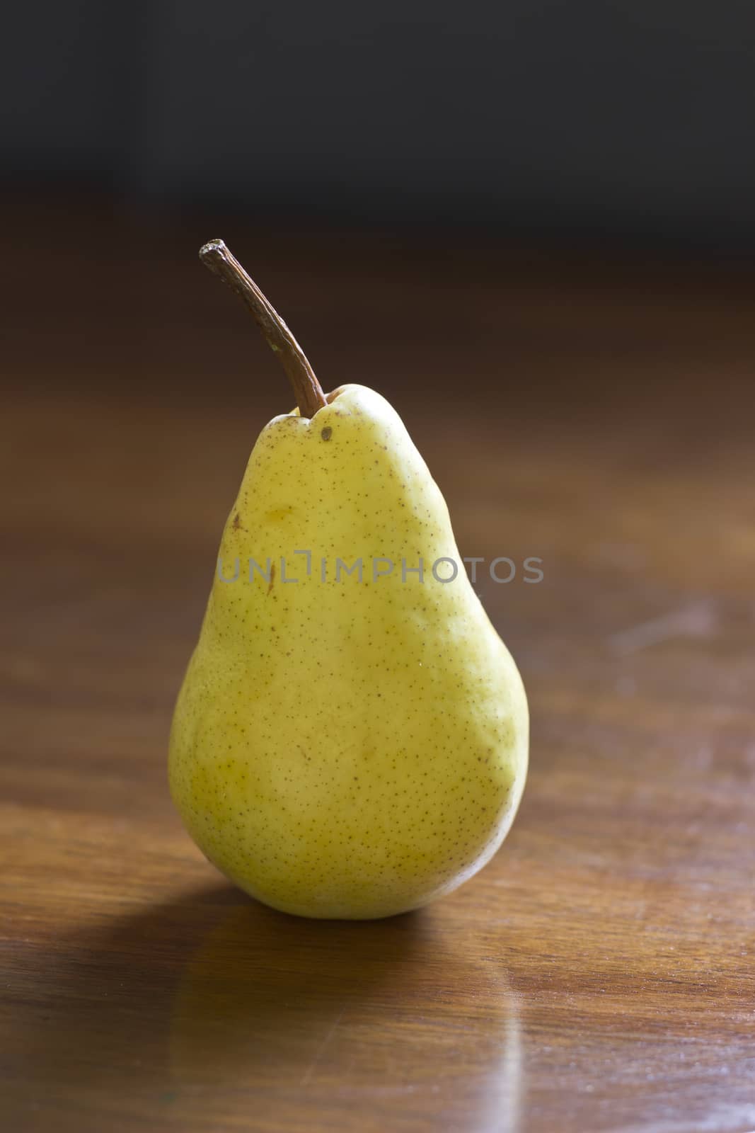 Pear on the wood background, natural light