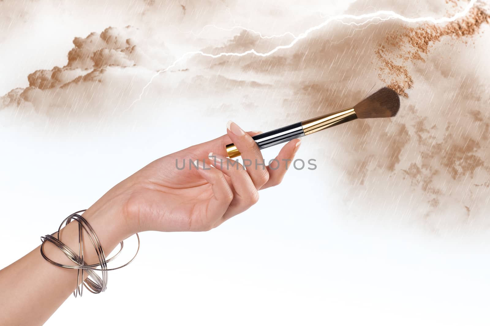 Close up view of woman’s hand holding brush on color back