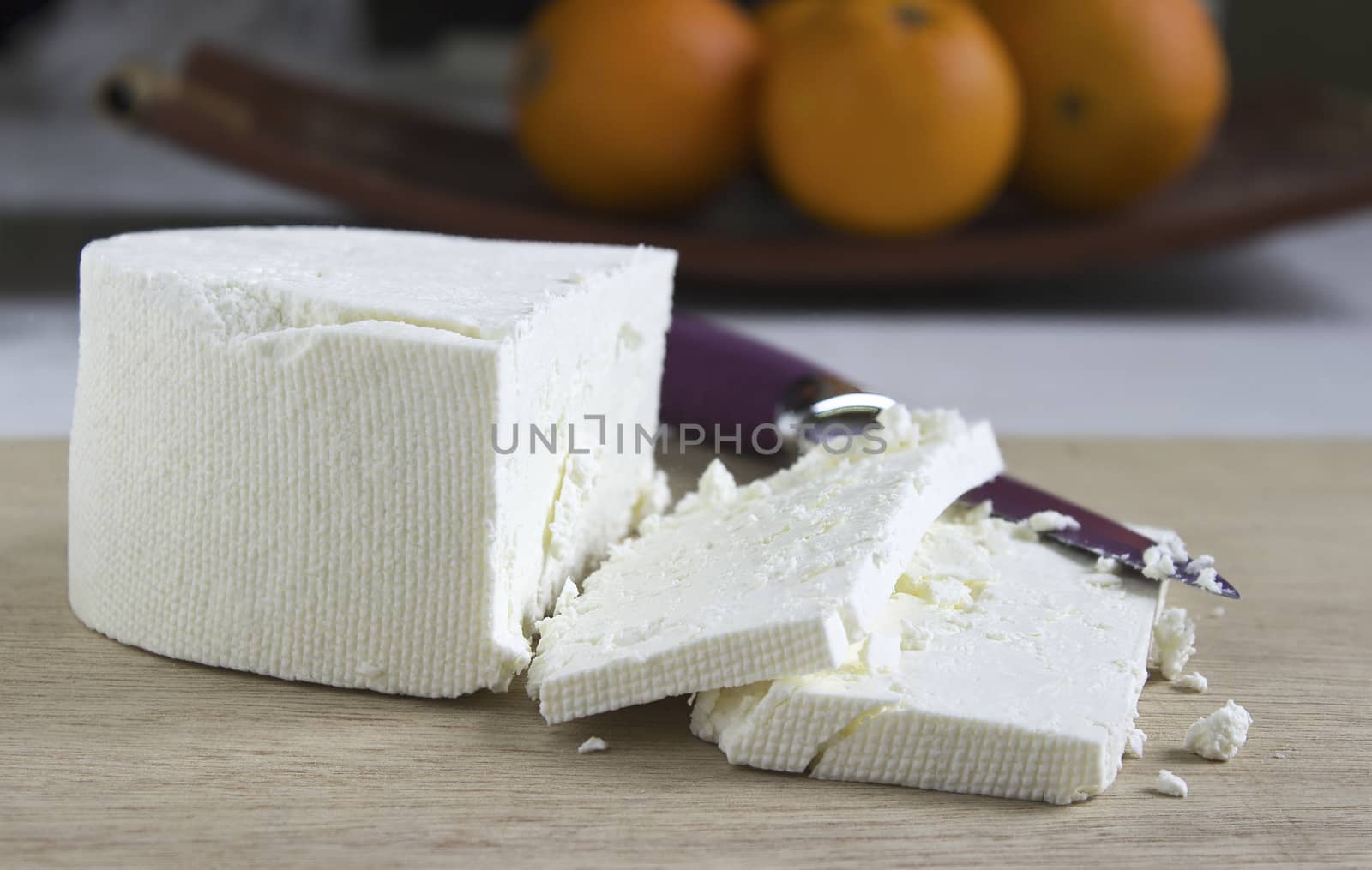 Feta cheese  on a wooden cutting board