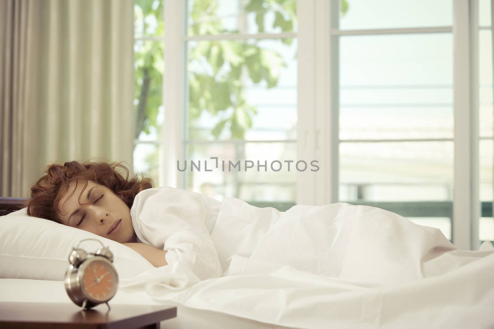 portrait of nice young woman sleeping in her bedroom