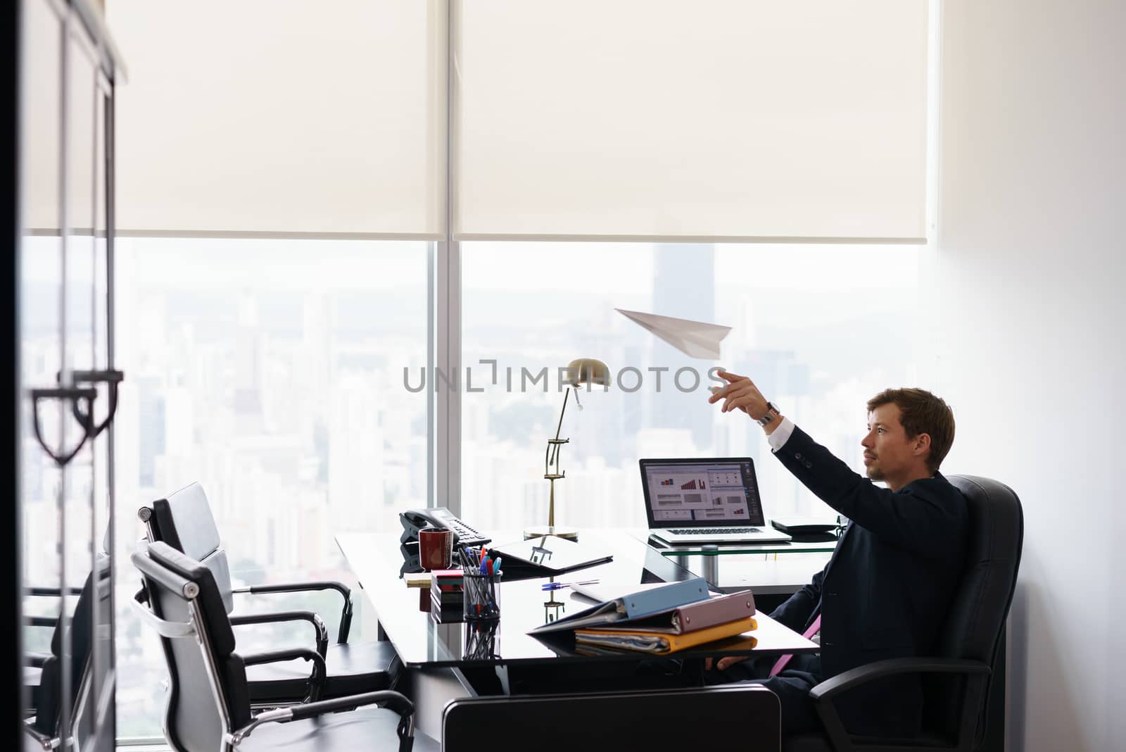 Successful Man Office Worker Daydreaming Throwing Paper Airplane by diego_cervo