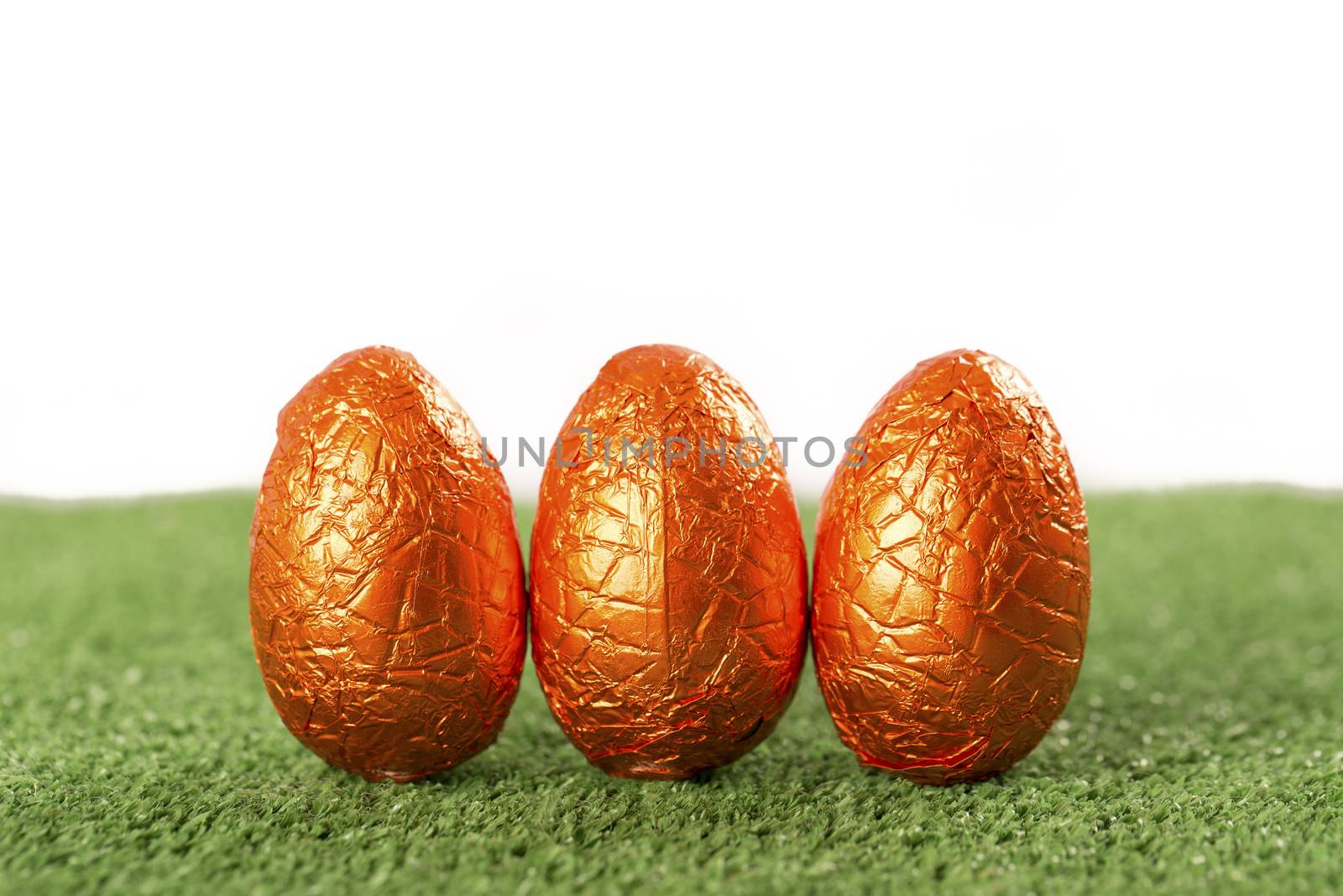 Group of colorful candy Easter eggs wrapped in foil 