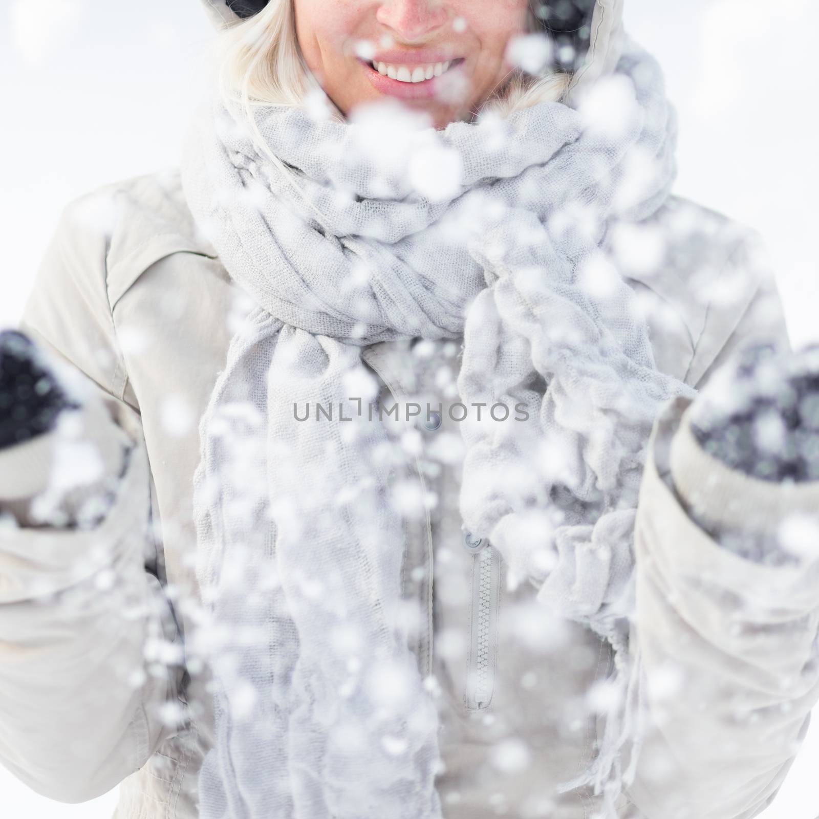 Girl  playing with snow in winter. by kasto