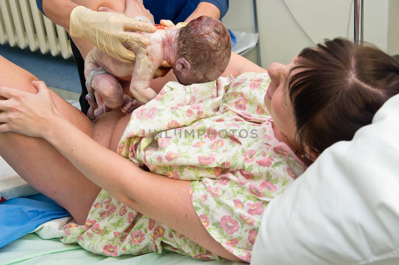 Young woman giving birth in maternity hospital