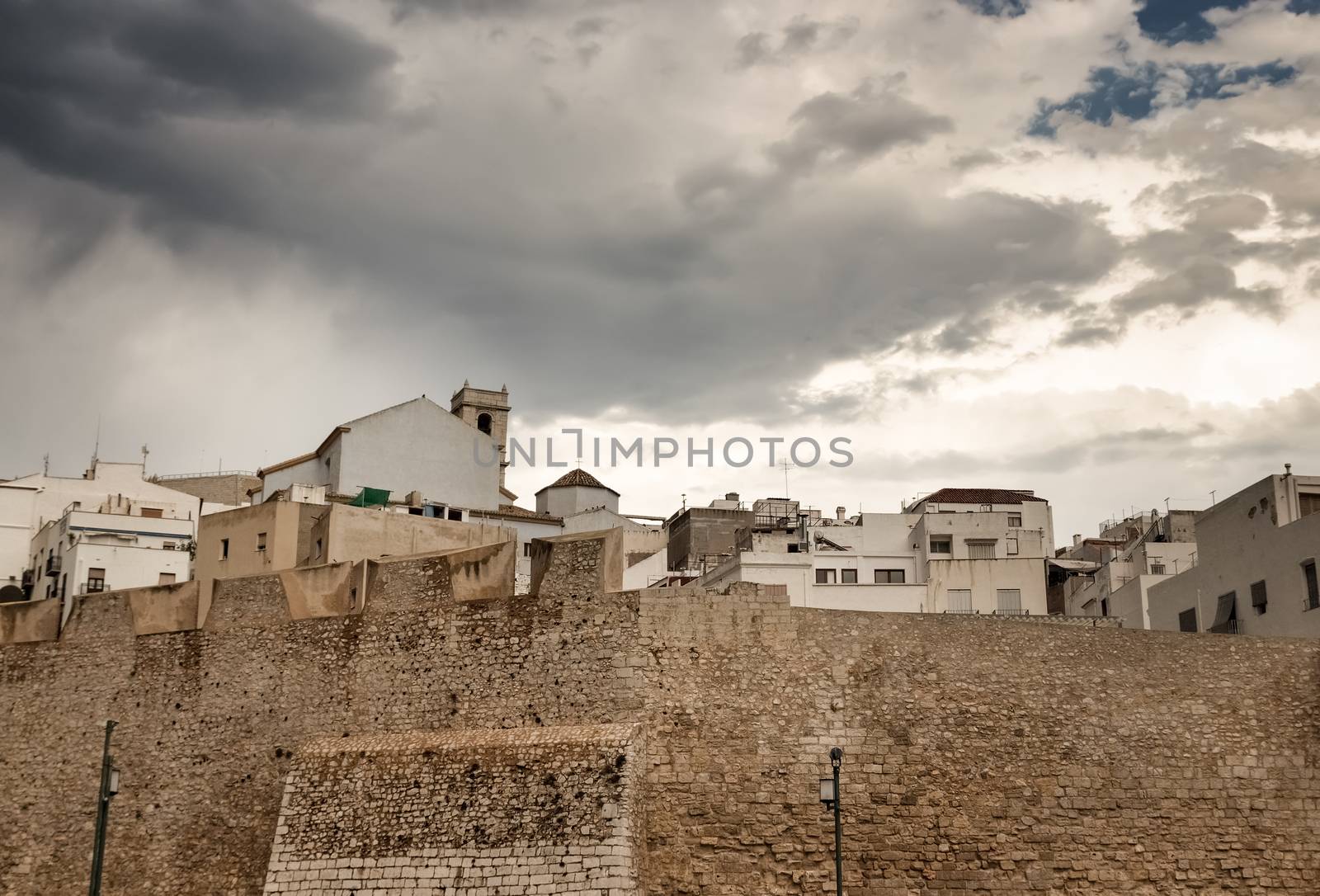 Dramatic sky over the houses of Peniscola, touristic town in the province of Castellon, Valencian Community, Spain.