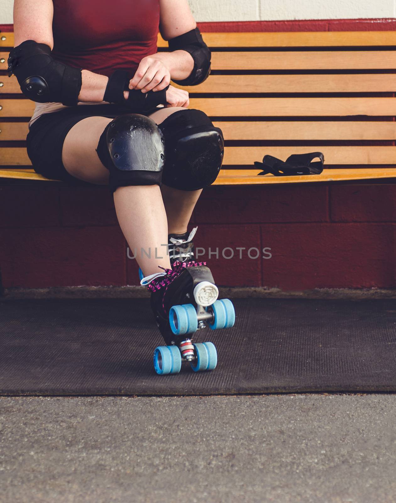 Woman on roller skates outside of a roller rink.