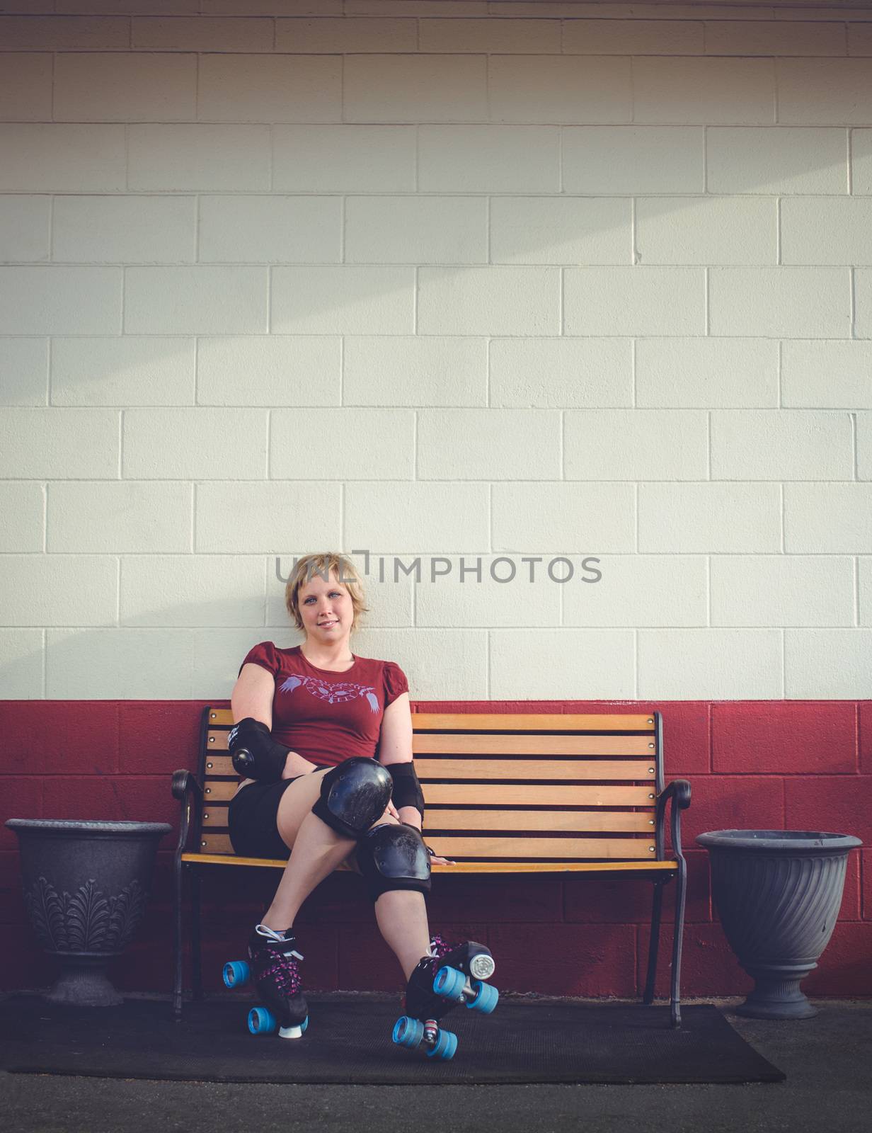 Woman on roller skates outside of a roller rink.