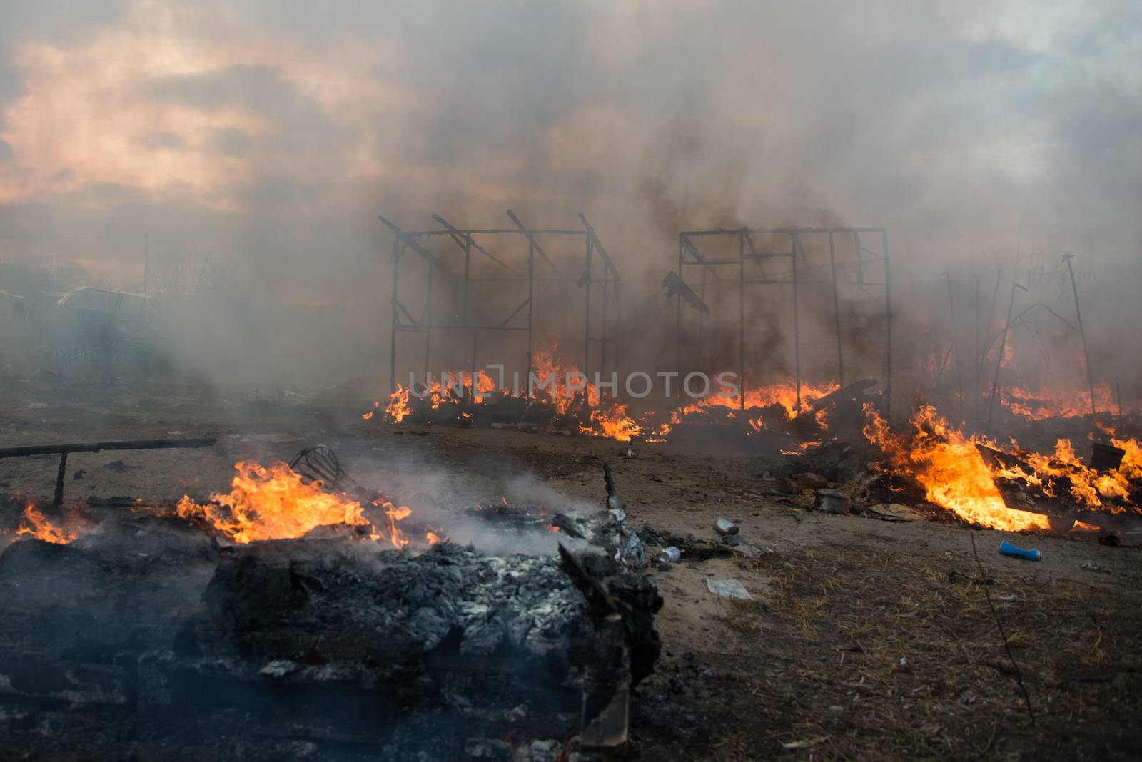 FRANCE, Calais: Fires set by just-evicted refugees ravage the 'Jungle' migrant camp in Calais, France on February 29, 2016. Residents of the controversial site in this northern town are being relocated as a new camp is being built. In protest, some set fire to the temporary homes at the camp.