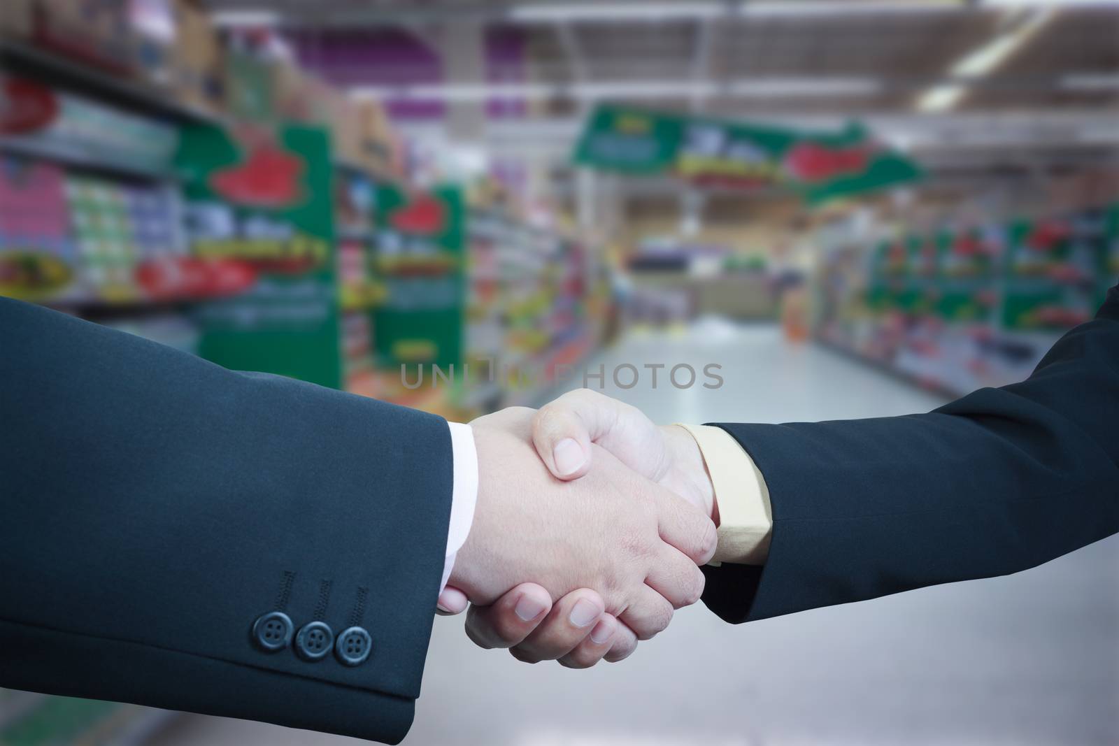 Business handshake with blur background of shopping mall