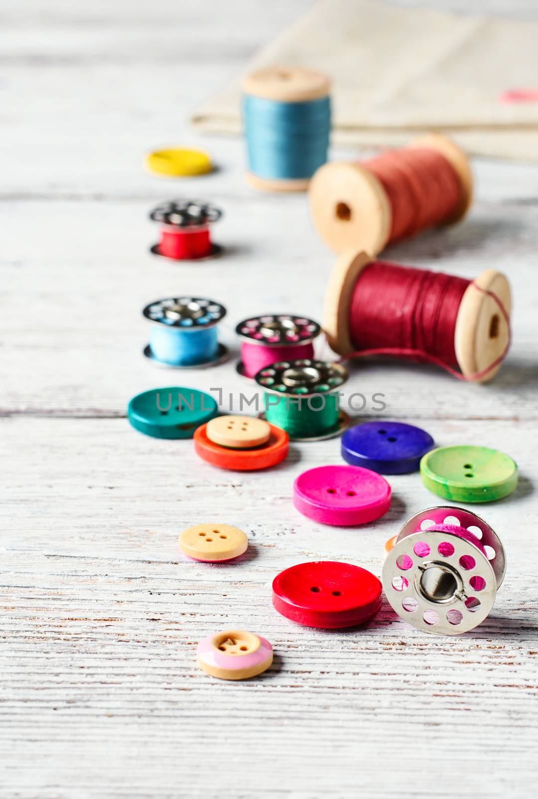 Beads,thread and bobbins for needlework.Picture in light key