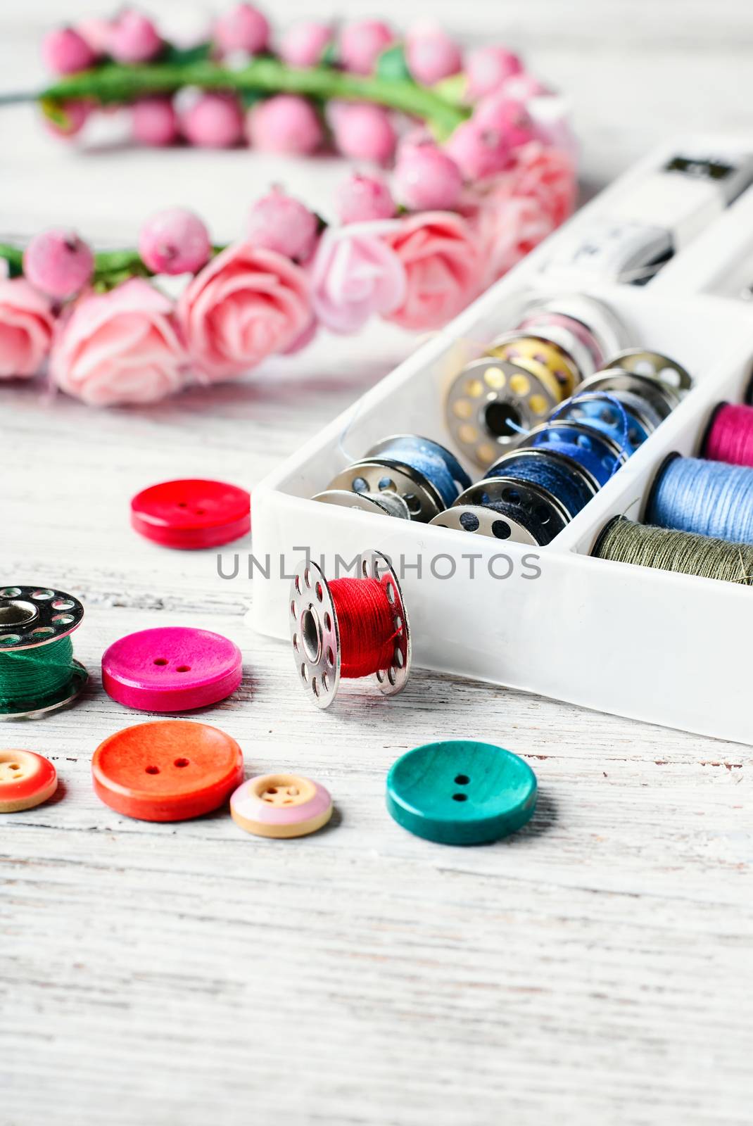 Beads,thread and bobbins for needlework.Picture in light key