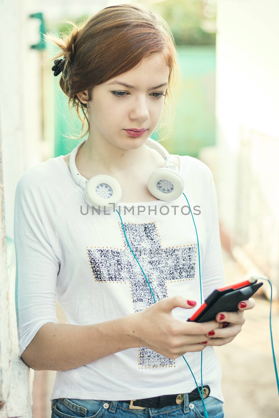 charming girl teen posing outdoors in bright sunlight