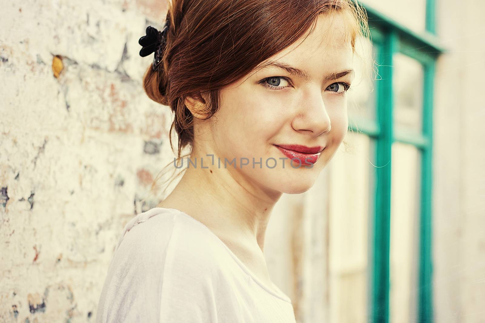 charming girl teen posing outdoors in bright sunlight