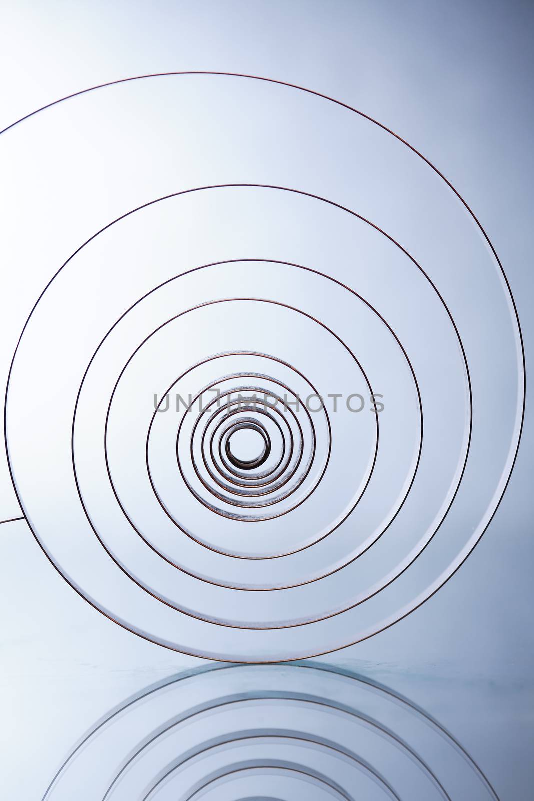 Industrial background. Closeup of old metal spiral on white background