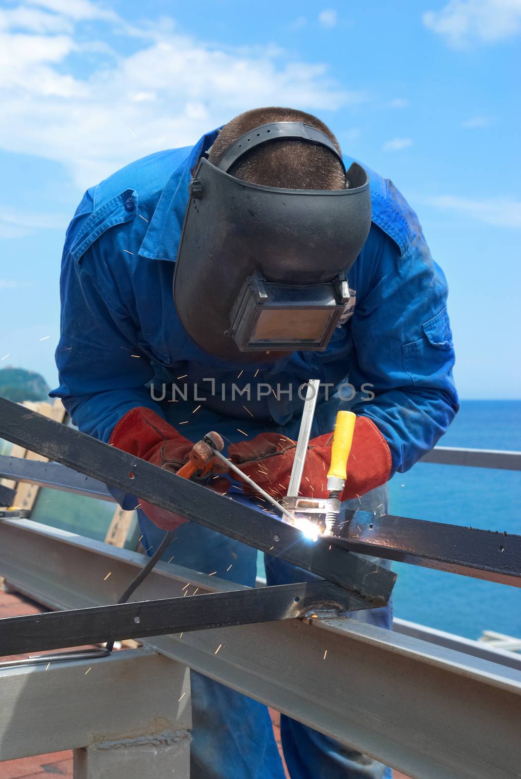 Welder at the factory working with metal construction