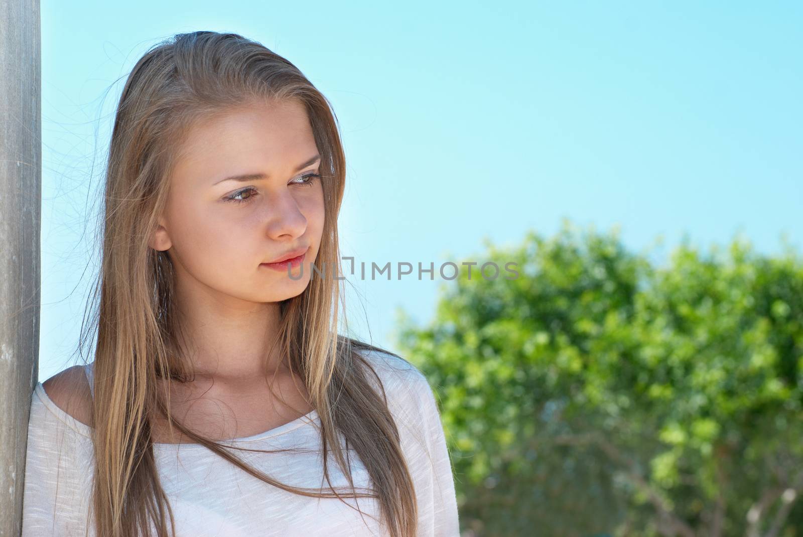 Beautiful blond girl outdoors against the sea