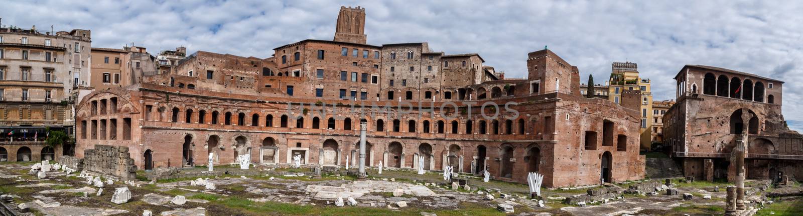 ROME, ITALY - SEPTEMBER 26, 2016 : View of an ancient Roman Forum with columns and ruins around in Rome, with tourists around, on cloudy sky background.