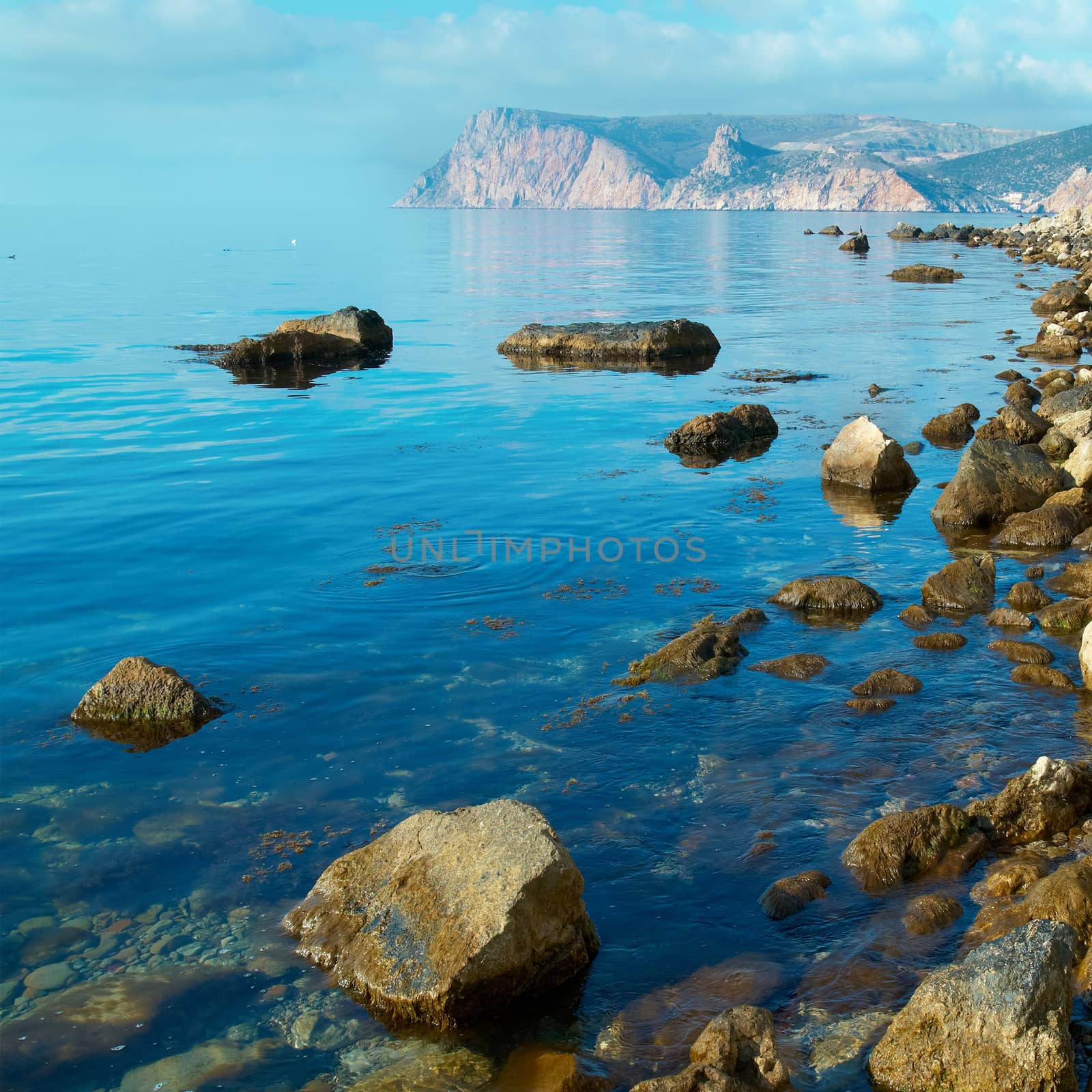 Sea, shore and stones. Seascape at sunset.