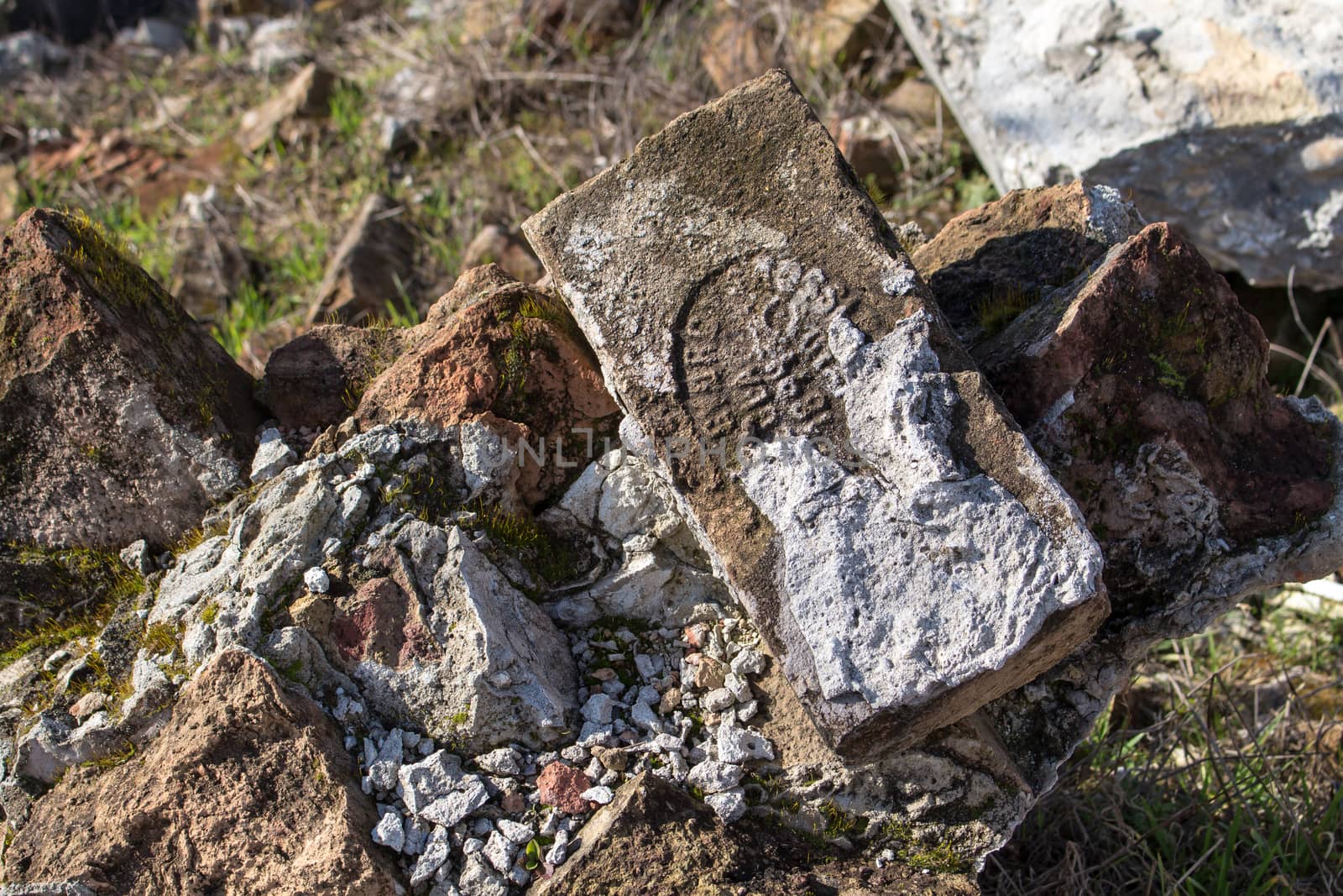 Brick on the pile of rubbish, partly dirty from cement. Still visible production year.