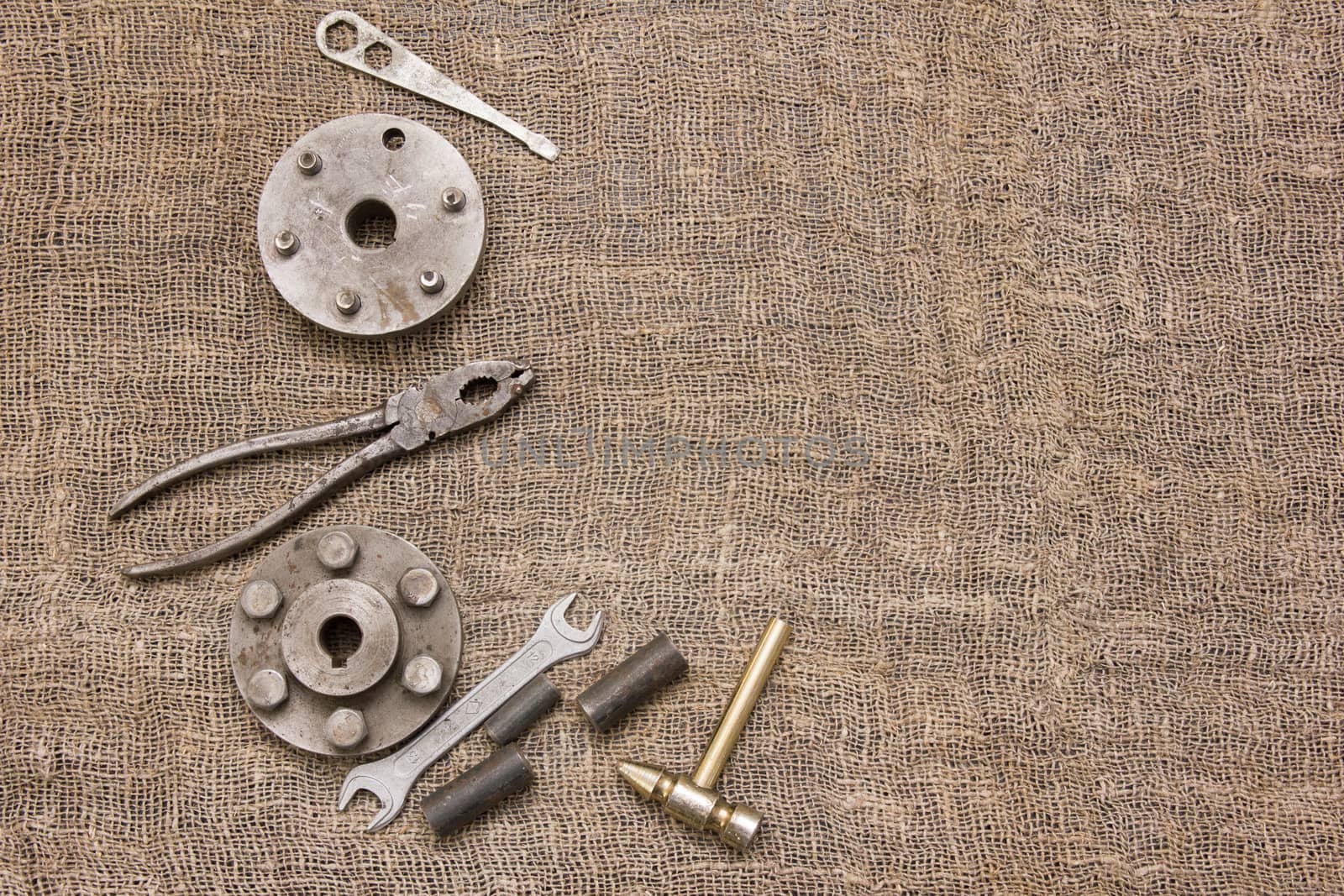 old rusty tools and details on the rough fabric. Instruments on sacking