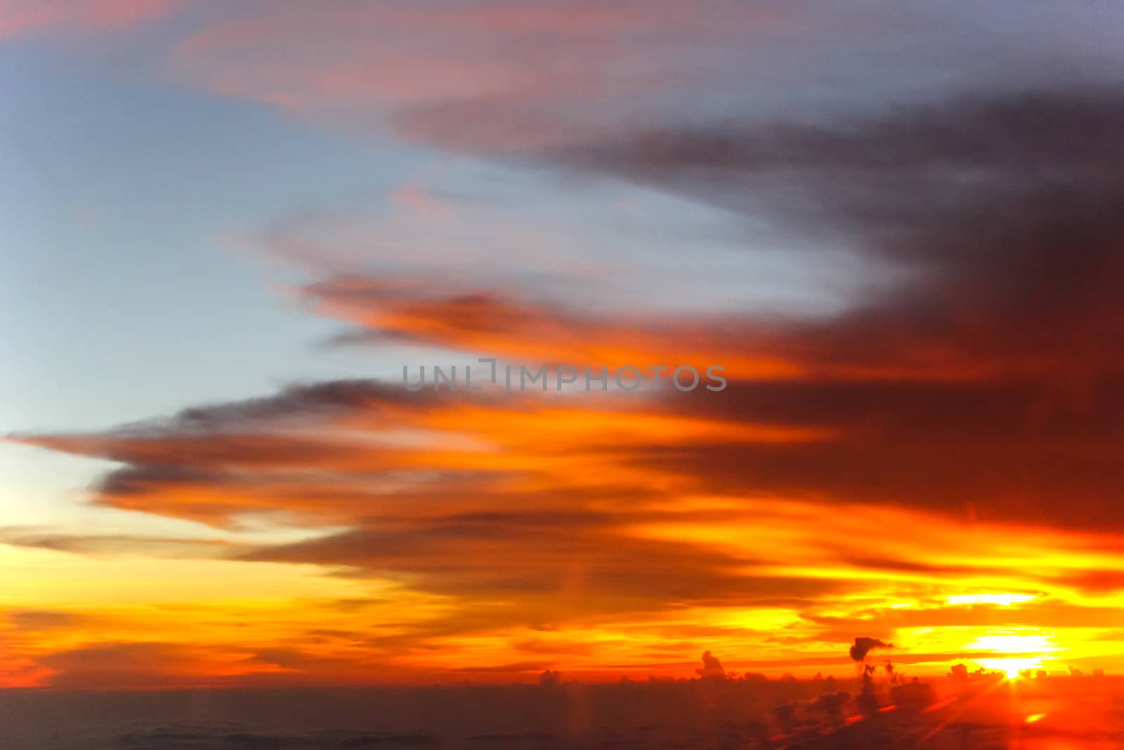 Sunset with clouds over view from airplane flying