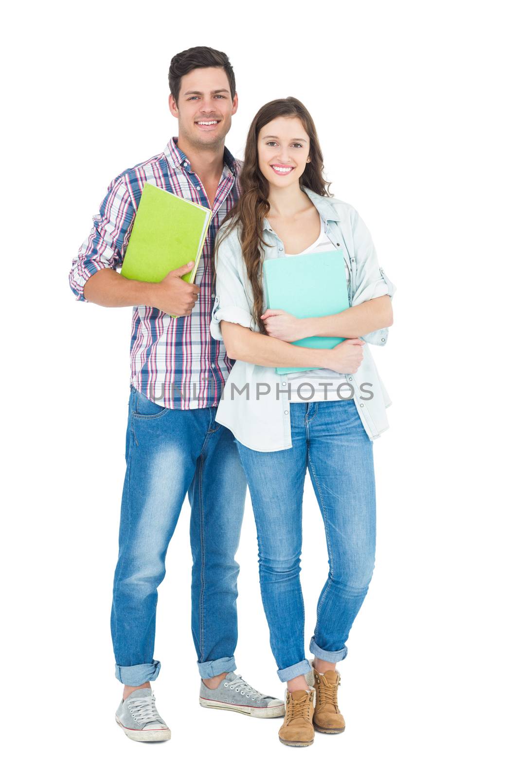 Portrait of students couple holding books  by Wavebreakmedia