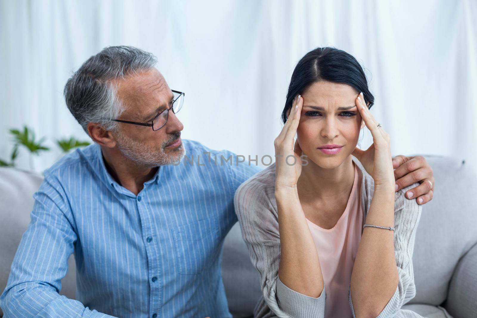 Therapist consoling a woman at home