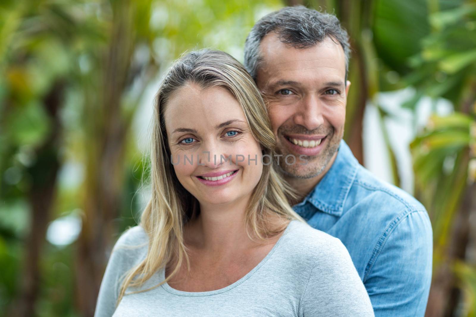 Couple looking at camera and smiling outdoors