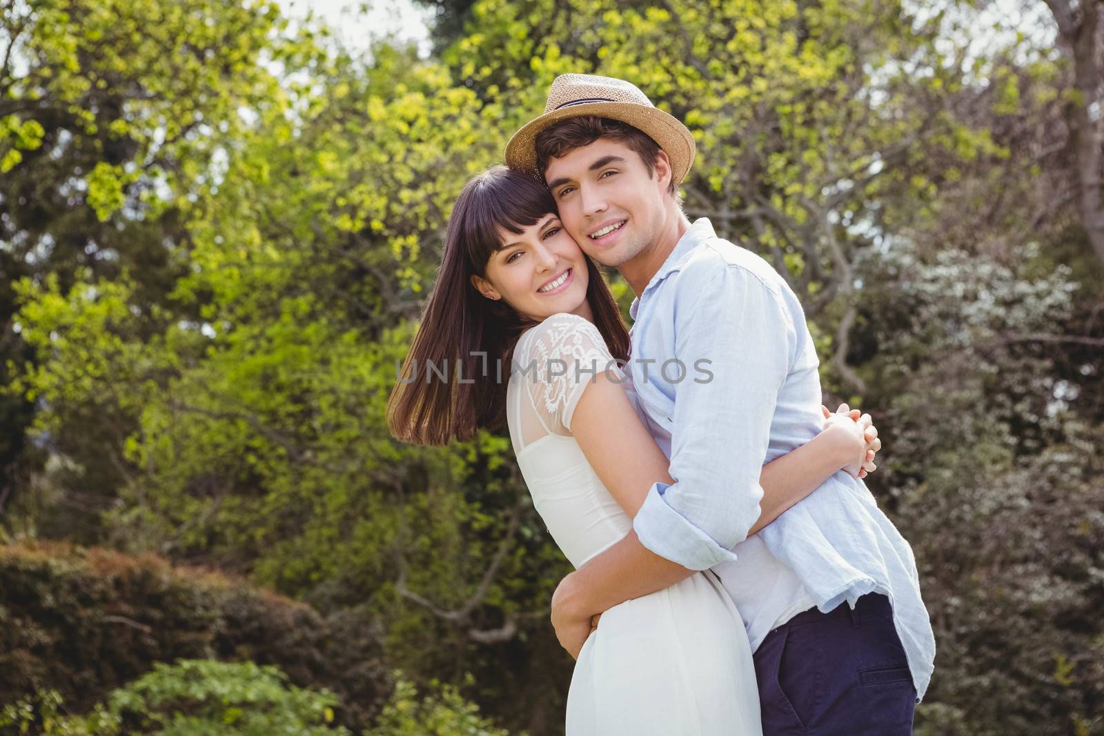 Portrait of young couple cuddling each other in garden