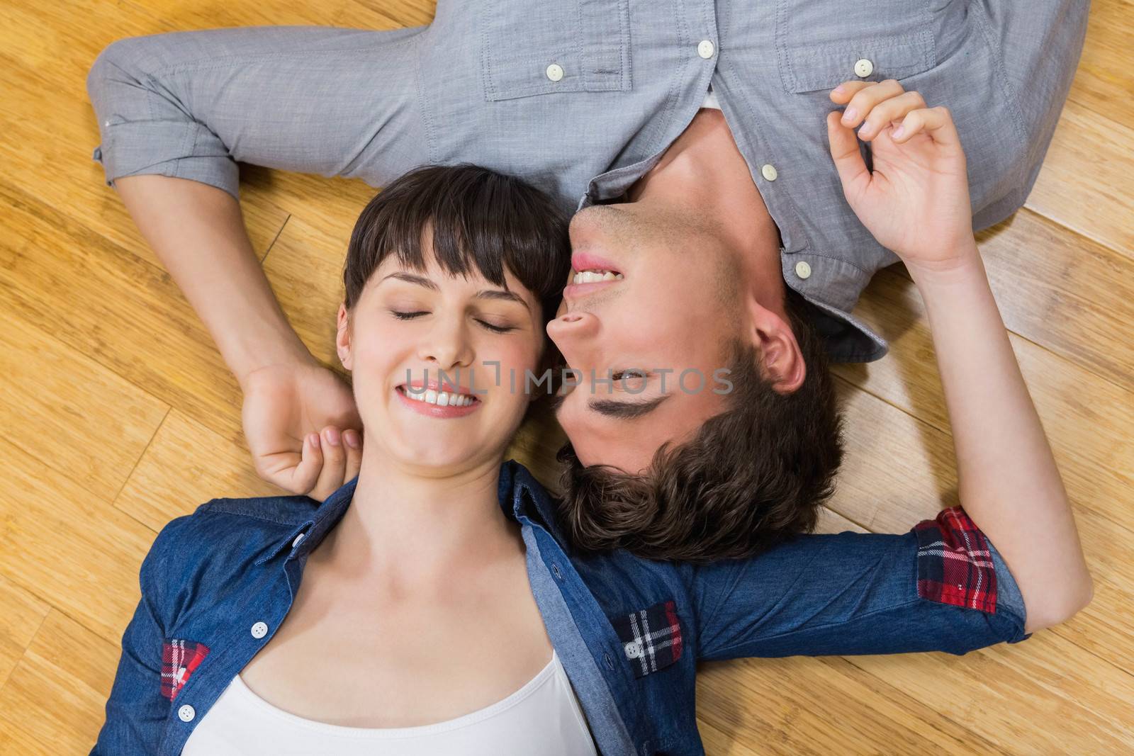 Couple at home relaxing on the floor by Wavebreakmedia