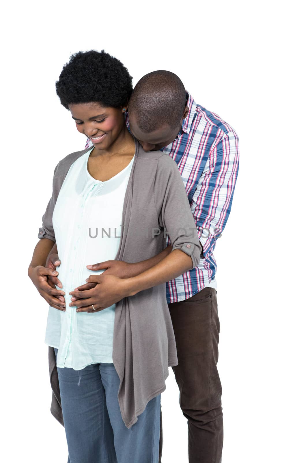 Pregnant couple smiling and embracing on white background