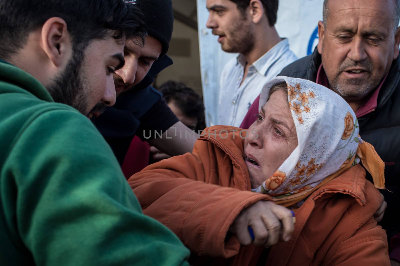 GREECE, Idomeni: A desperate woman cries as she tries to set herself on fire on March 1, 2016 in Idomeni to protest against Macedonia's decision to close its border. 