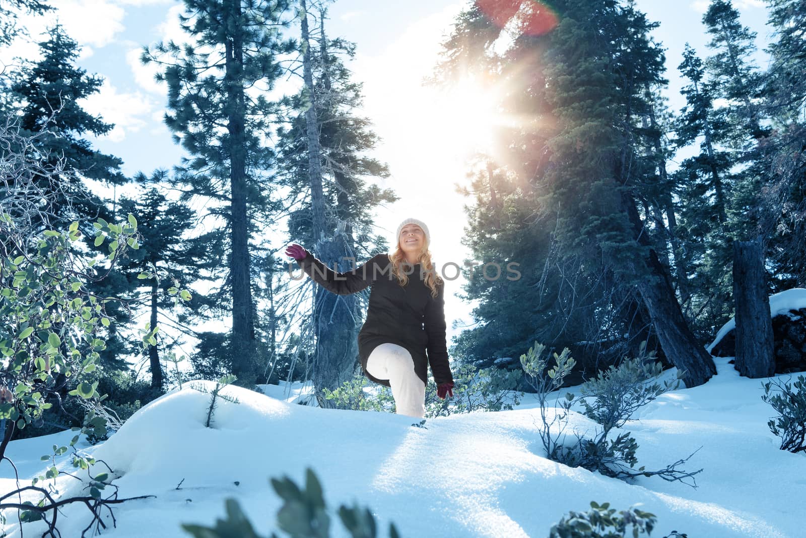 Portrait of young beautiful woman on winter outdoor background