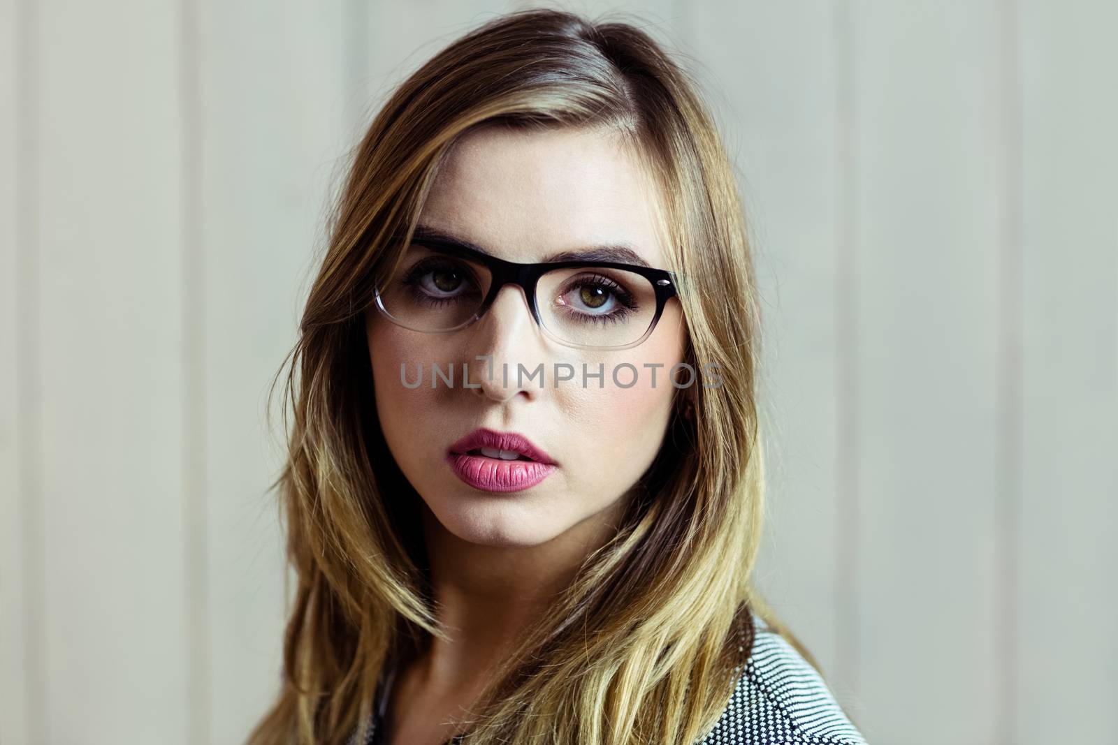 Pretty blonde woman day dreaming on wooden background