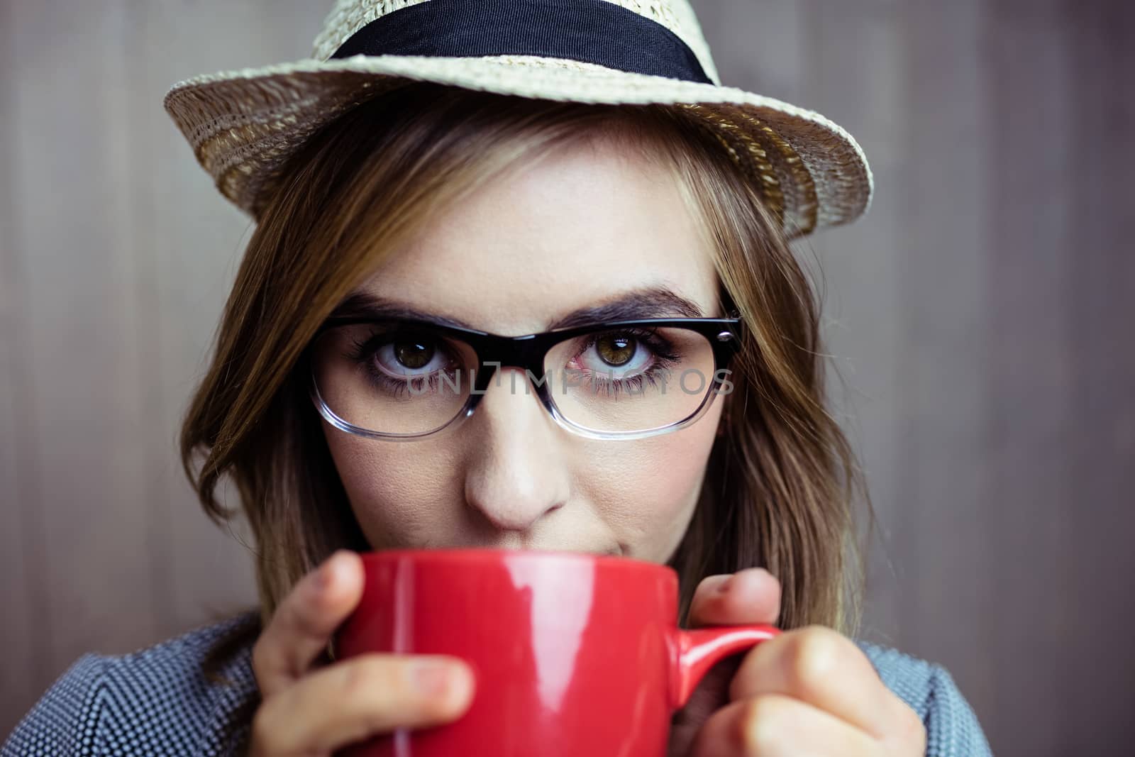 Pretty blonde woman having coffee on wooden background