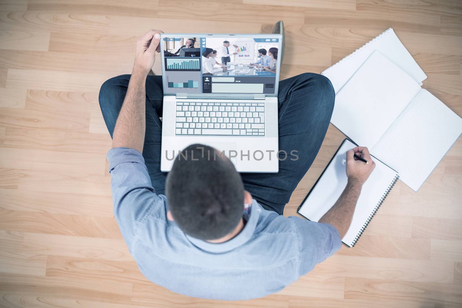 Screen with graphs against young creative businessman working on laptop