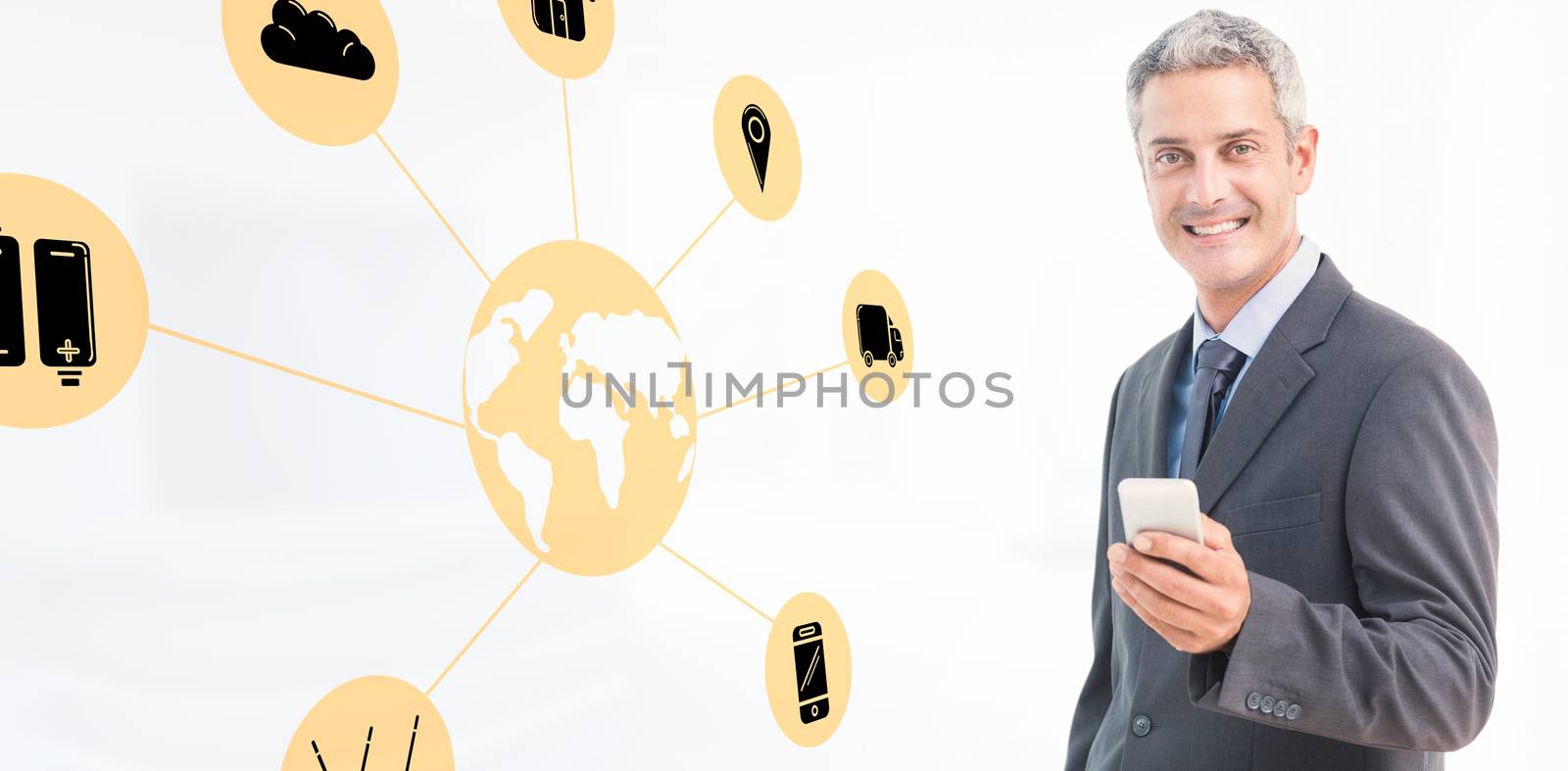 Portrait of smiling businessman holding mobile phone against modern room overlooking city