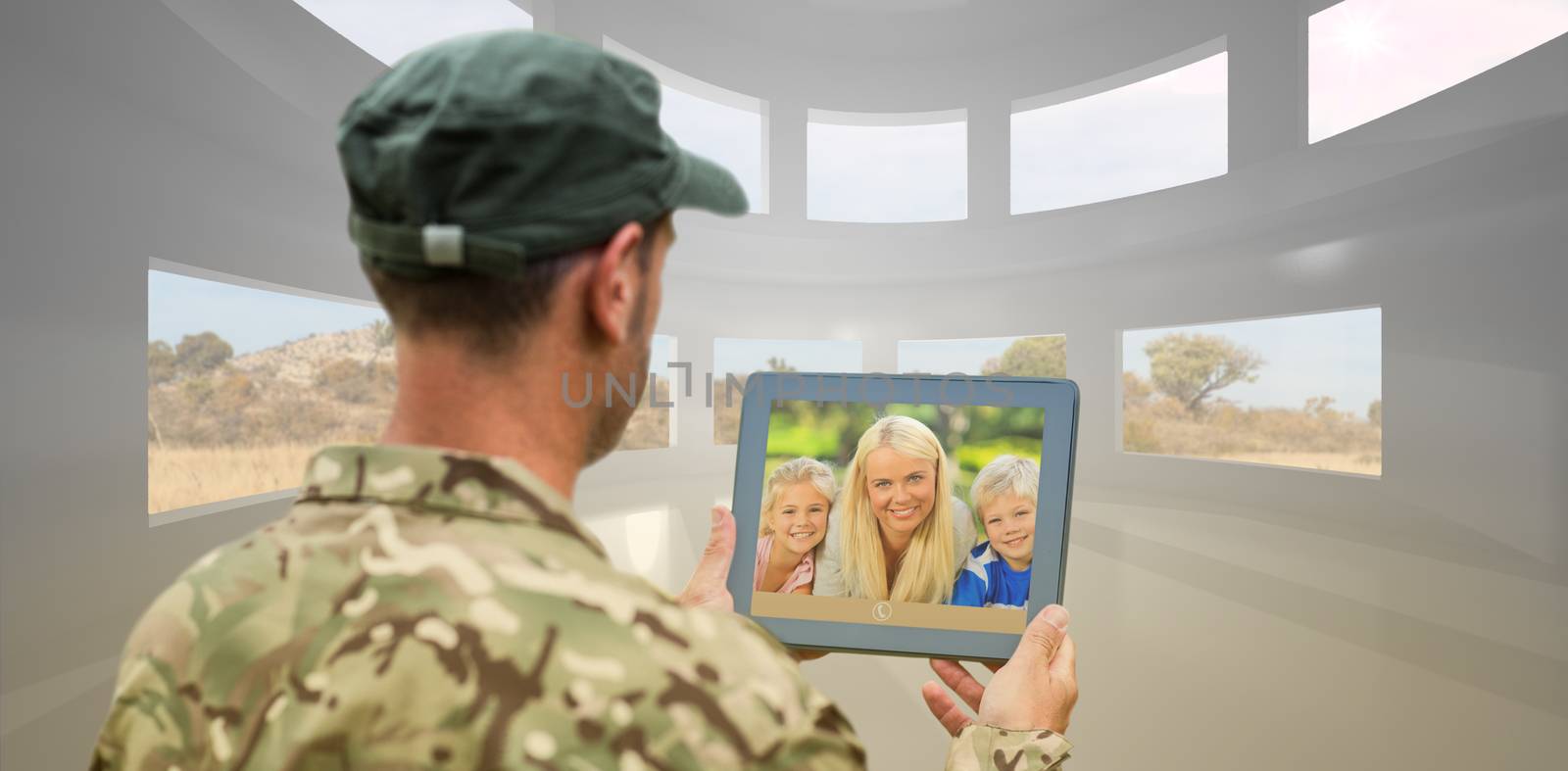 Soldier using tablet pc against bright room with windows