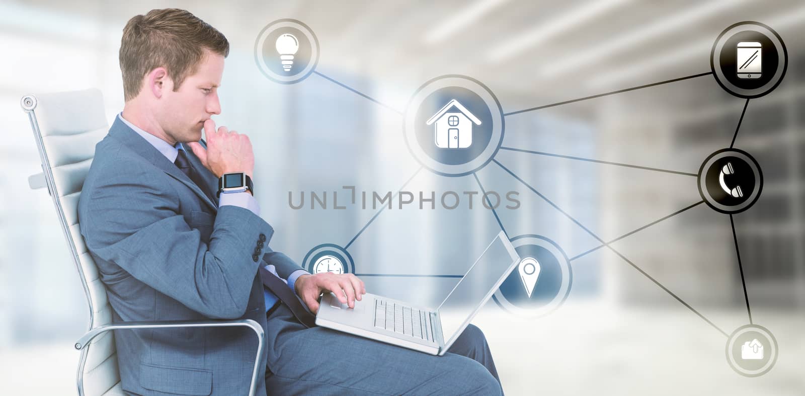 Handsome businessman using his laptop against modern room overlooking city