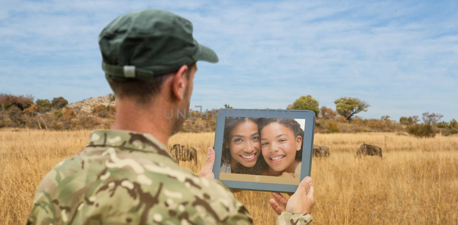 Composite image of soldier using tablet pc by Wavebreakmedia