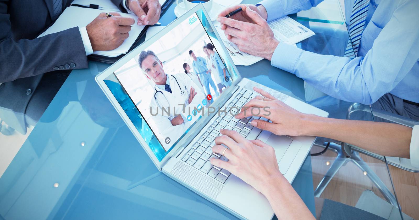 Business people in discussion in an office against smiling doctor with arms crossed
