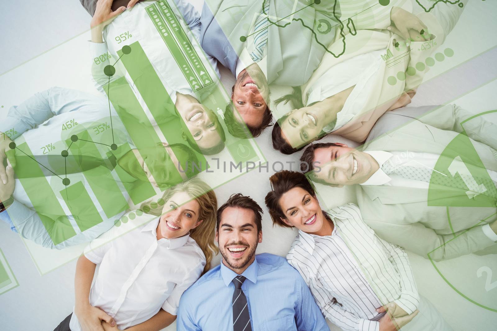 Young business people lying in circle against digitally generated image of pie chart and bar graph
