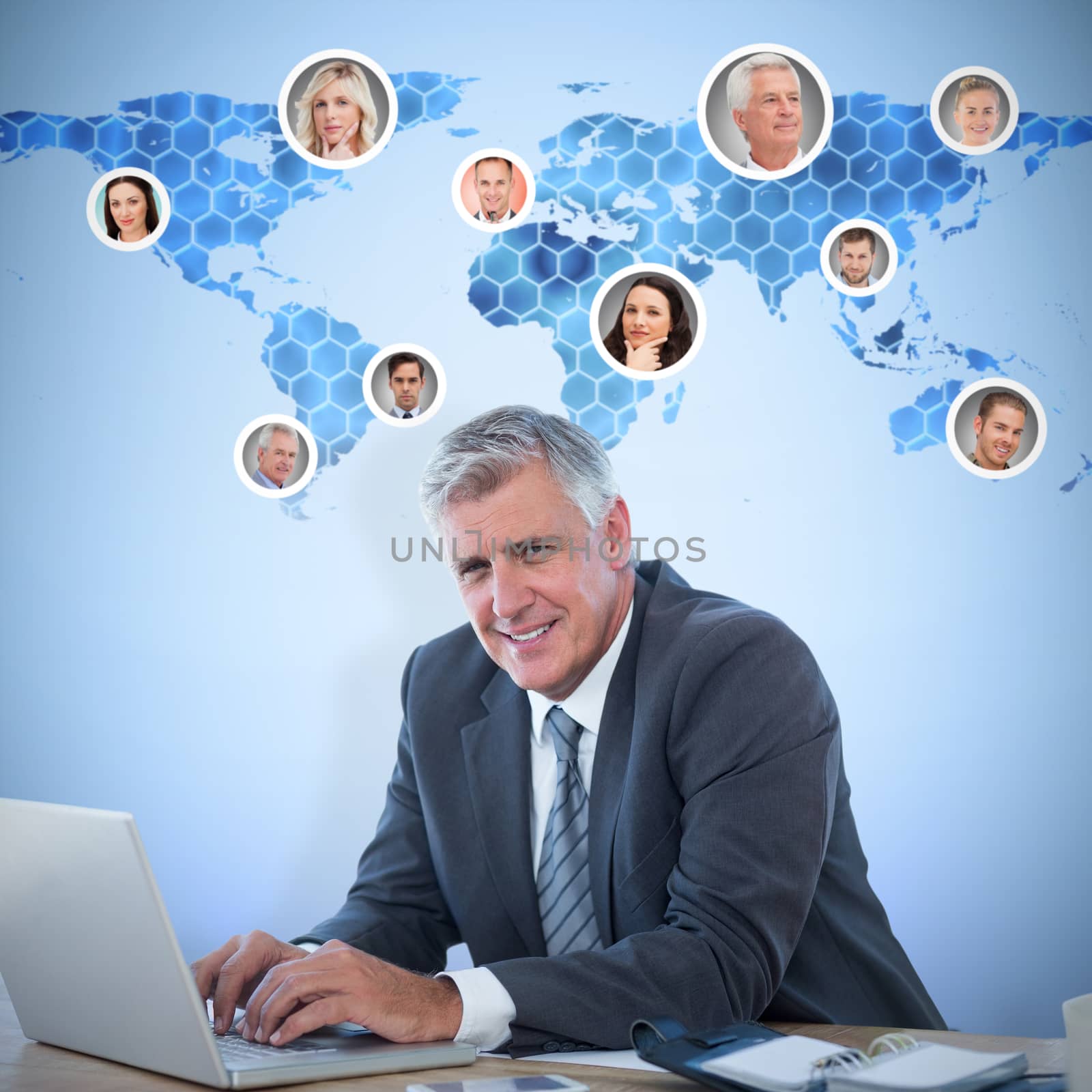Smiling businessman working with his laptop against background with hexagons and world map