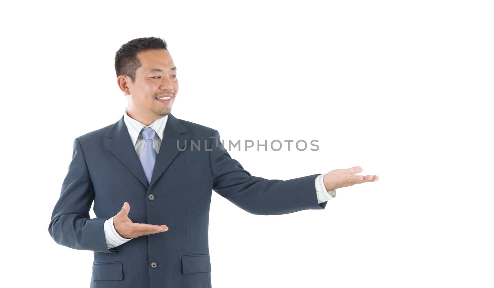 portrait of young happy smiling cheerful asian business man hand showing blank copy space; isolated over white background