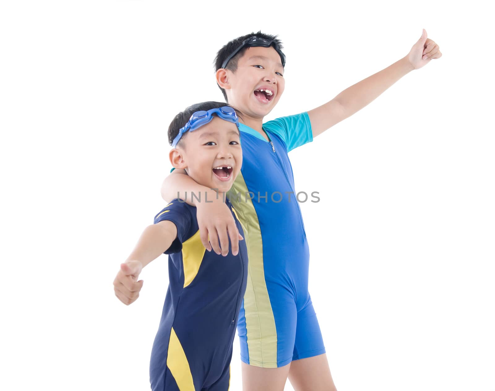 Young asian boys in swimsuit and swim goggles on isolated white backdround.