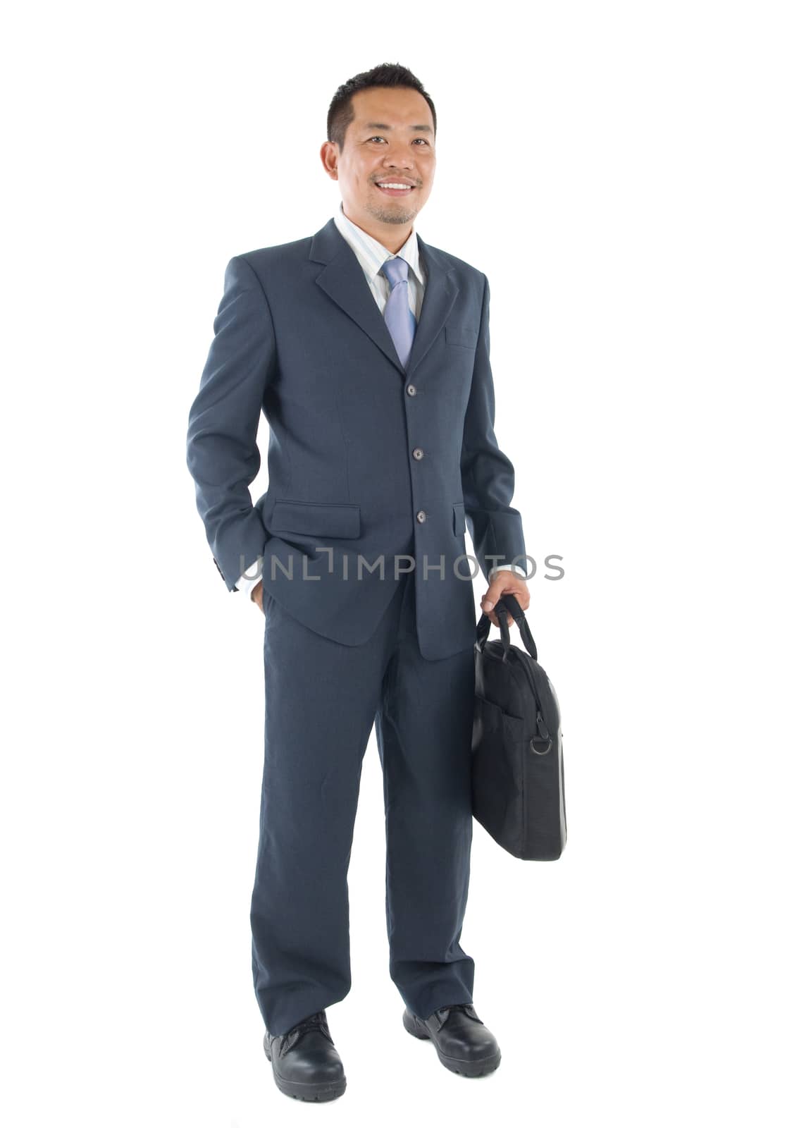 Handsome business man of Southeast Asian, full length portrait.