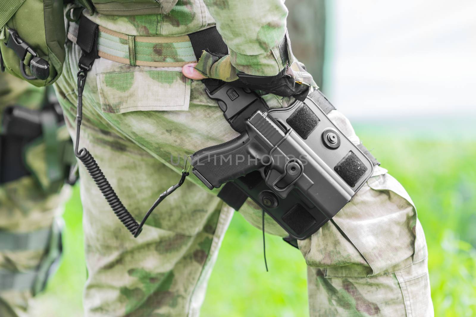 Military man with a gun on his leg