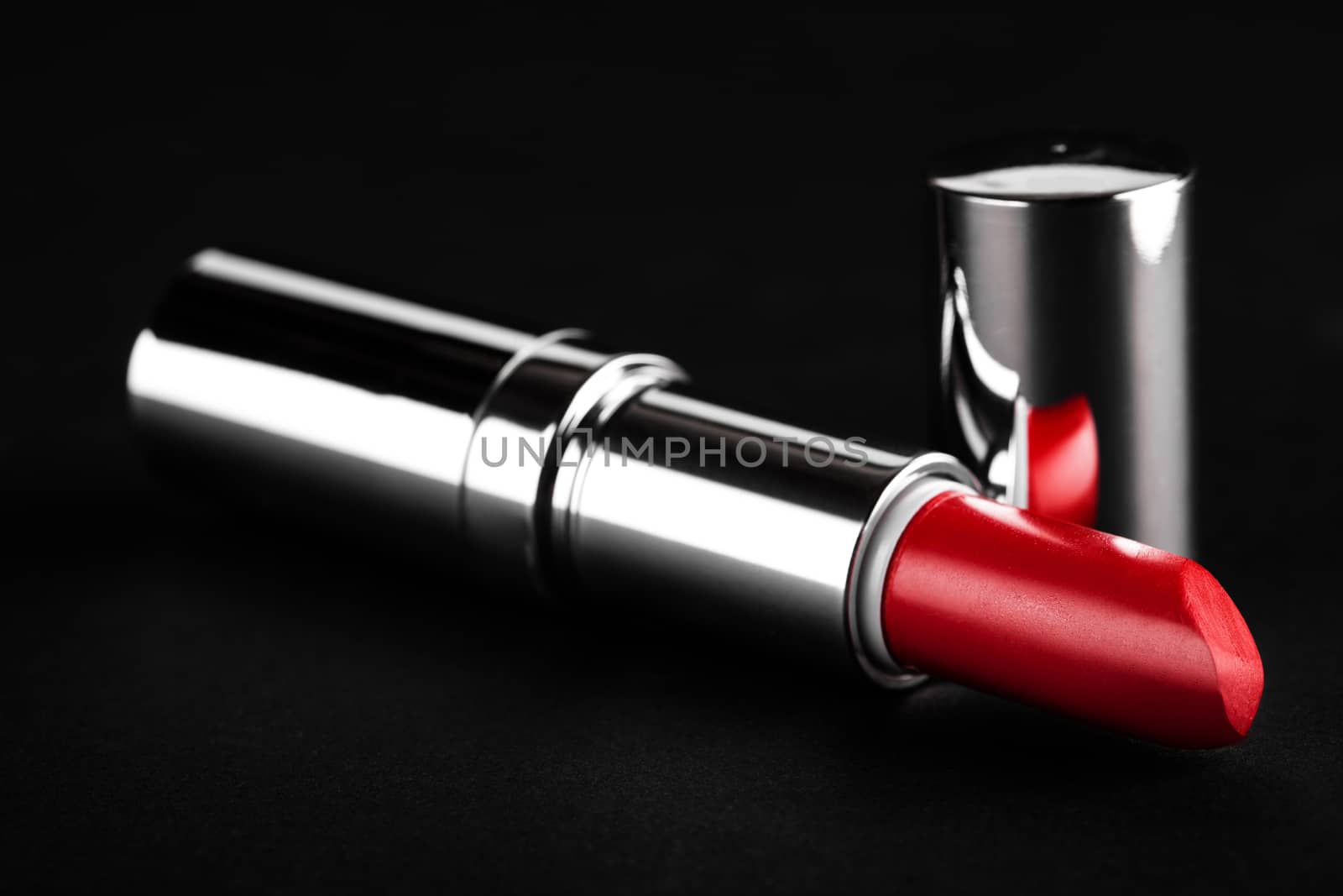 open red lipstick closeup on a black background