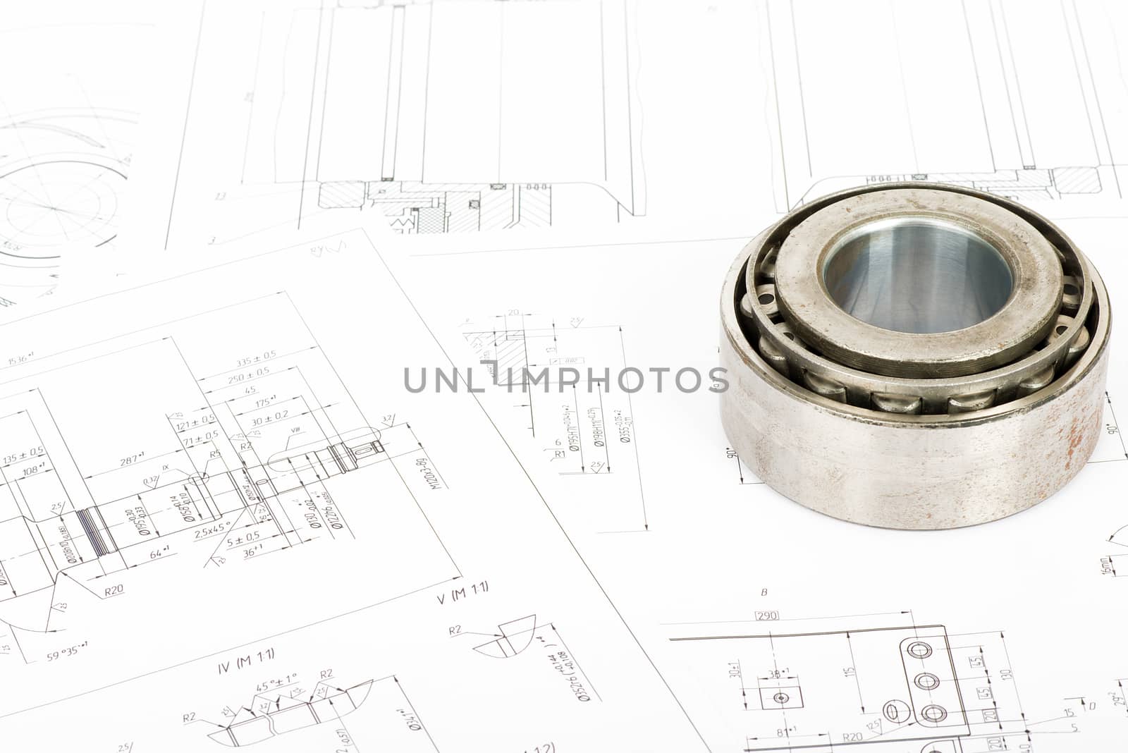 Roller bearing on blue prints, close up view